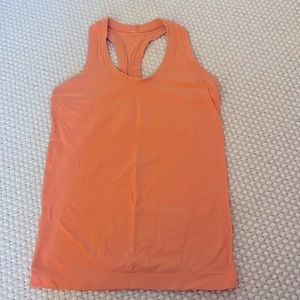 Coral orange Athleta tank top.